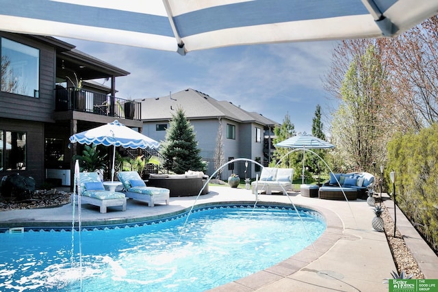 outdoor pool featuring a patio and an outdoor living space