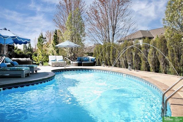 view of pool featuring outdoor lounge area, a fenced in pool, and a patio
