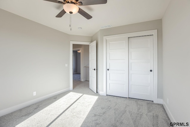 unfurnished bedroom with light carpet, visible vents, and baseboards