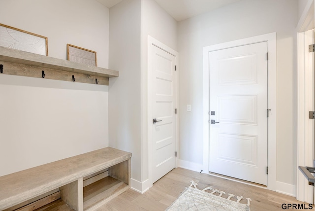 mudroom with light wood finished floors and baseboards