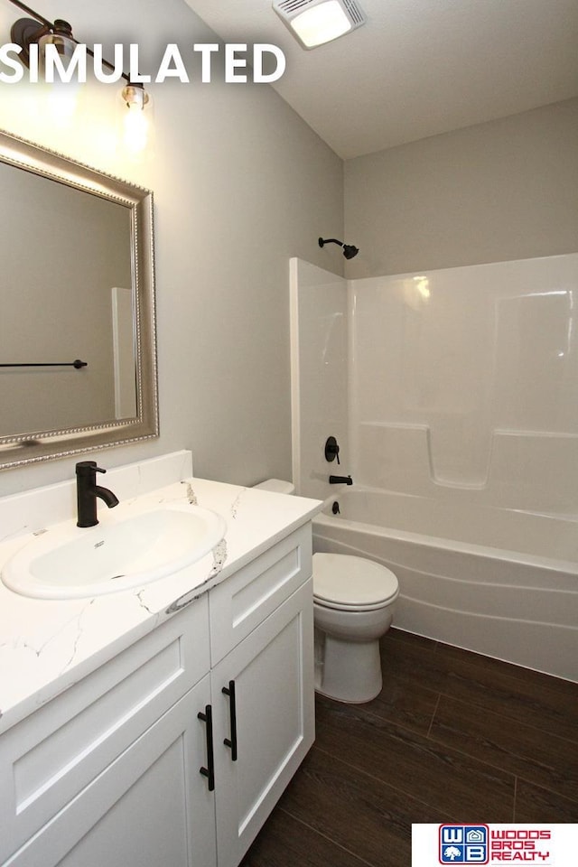 full bathroom featuring wood finished floors, vanity, tub / shower combination, toilet, and visible vents