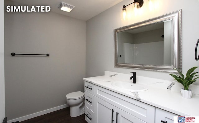 bathroom featuring wood finished floors, visible vents, toilet, vanity, and baseboards