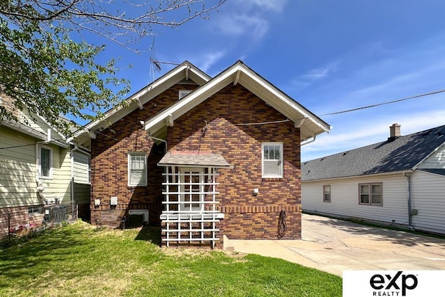5238 S 20th St, Omaha, NE 68107 - rear view of house featuring brick siding and a yard
