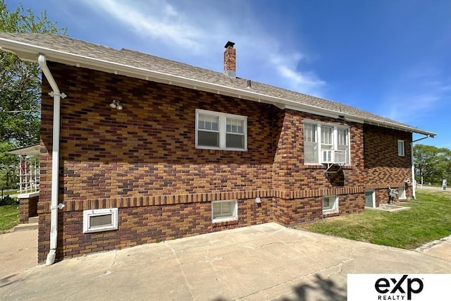 5238 S 20th St, Omaha, NE 68107 - view of side of home featuring a patio, a chimney, brick siding, and a yard