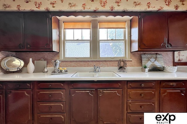 5238 S 20th St, Omaha, NE 68107 - kitchen featuring healthy amount of natural light, light countertops, a sink, and wallpapered walls