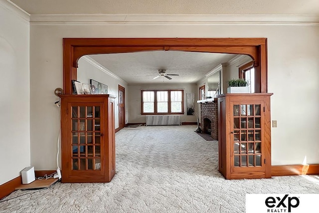 5238 S 20th St, Omaha, NE 68107 - living area featuring ornamental molding, radiator, carpet floors, ceiling fan, and a brick fireplace