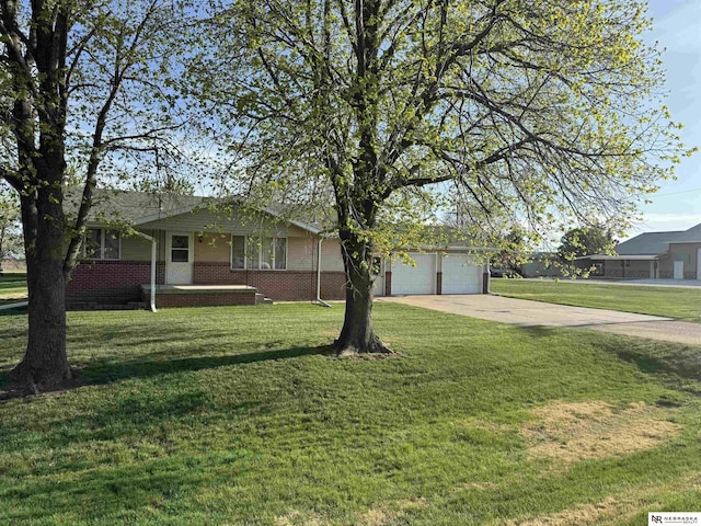 103 Francis St, Daykin, NE 68338 - ranch-style home with driveway, a garage, brick siding, and a front yard