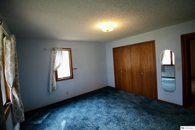 103 Francis St, Daykin, NE 68338 - unfurnished bedroom featuring carpet floors, a closet, and a textured ceiling