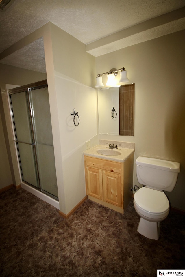 103 Francis St, Daykin, NE 68338 - bathroom with a stall shower, toilet, vanity, baseboards, and a textured ceiling