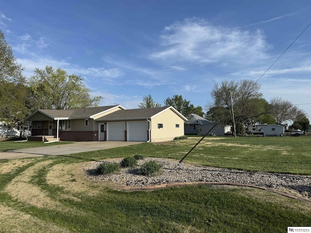 103 Francis St, Daykin, NE 68338 - view of front of home with a garage, a front yard, driveway, and brick siding