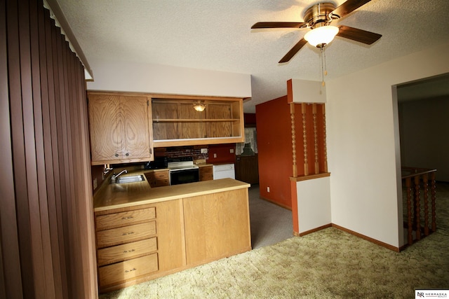 103 Francis St, Daykin, NE 68338 - kitchen featuring a sink, electric stove, carpet flooring, a ceiling fan, and a peninsula