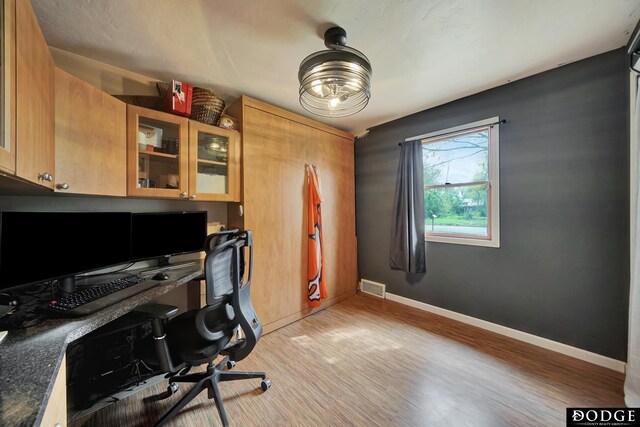 3317 N 9th St, Lincoln, NE 68521 - home office with baseboards, light wood-style flooring, and visible vents