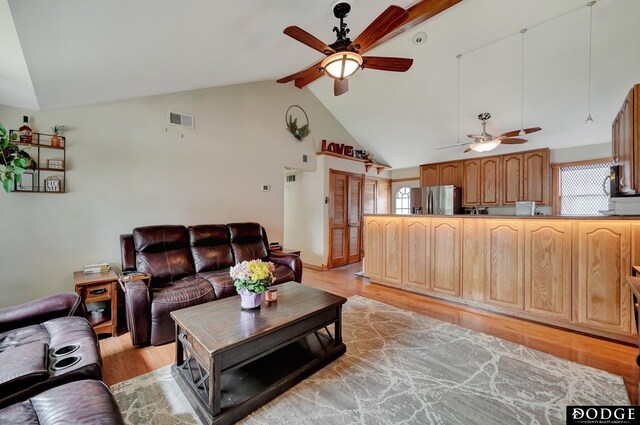 3317 N 9th St, Lincoln, NE 68521 - living area with light wood finished floors, visible vents, beamed ceiling, a ceiling fan, and high vaulted ceiling