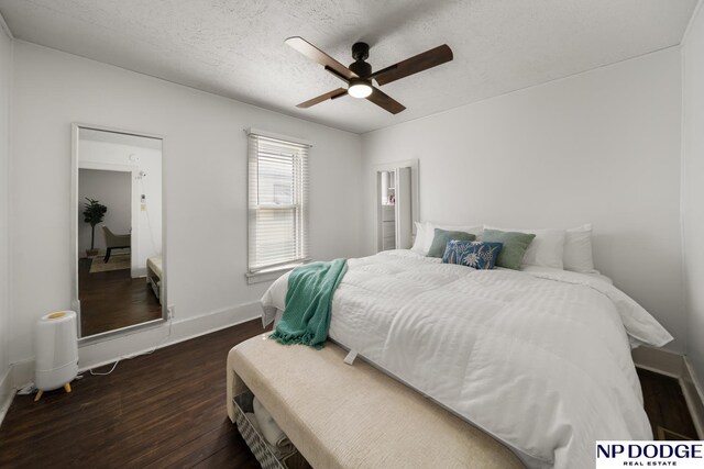 bedroom featuring baseboards, ceiling fan, and dark wood finished floors