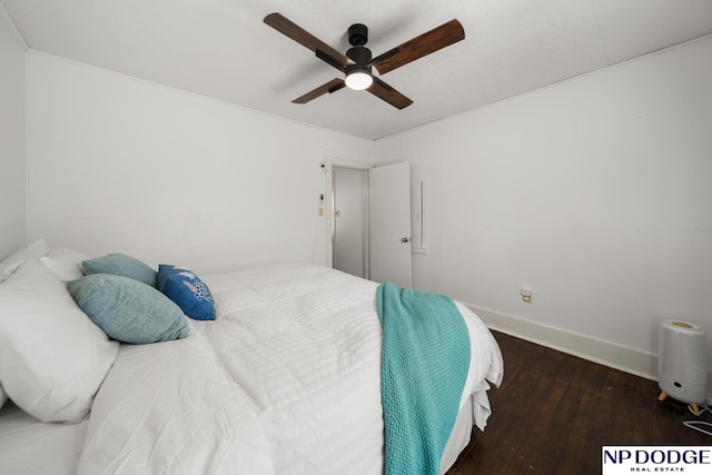 bedroom featuring baseboards, wood finished floors, and ceiling fan