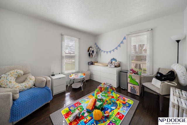 bedroom with hardwood / wood-style floors and a textured ceiling