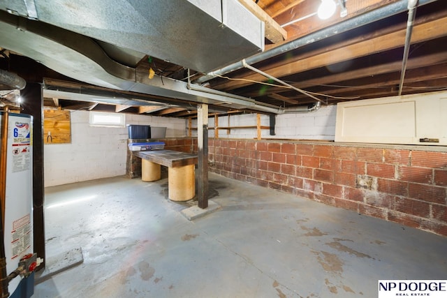 below grade area with water heater and concrete block wall