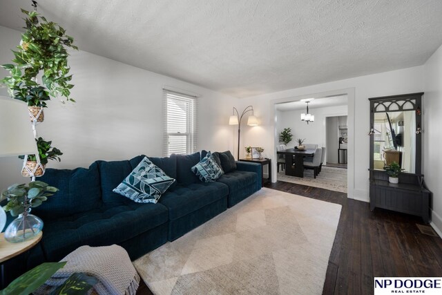 living room with baseboards and dark wood-type flooring
