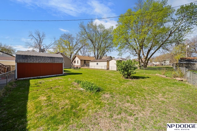 view of yard featuring a fenced backyard, an outdoor structure, and a shed