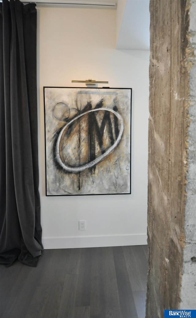 details featuring wood finished floors and baseboards