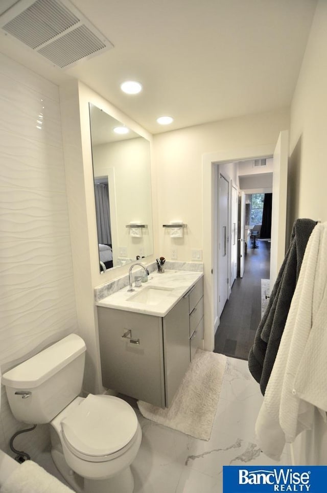 bathroom with recessed lighting, visible vents, toilet, and vanity