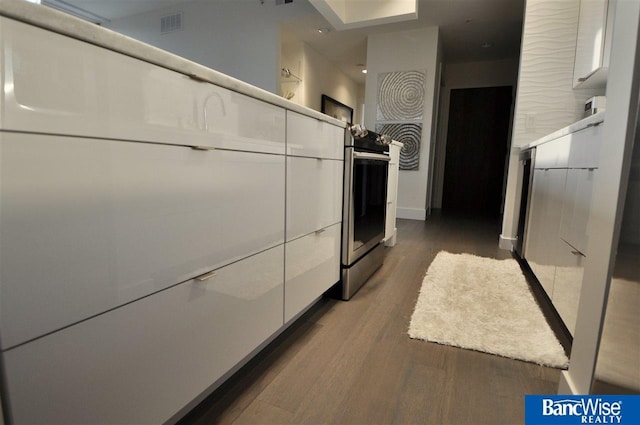 interior space featuring dark wood-type flooring and baseboards