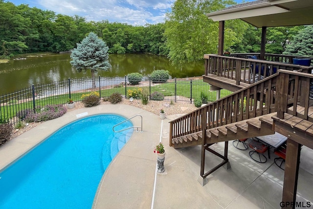 view of swimming pool featuring fence, a patio area, a fenced in pool, and a deck with water view