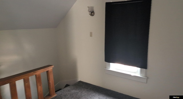 interior space with vaulted ceiling and carpet floors