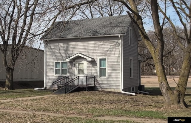 view of front of home featuring a shingled roof
