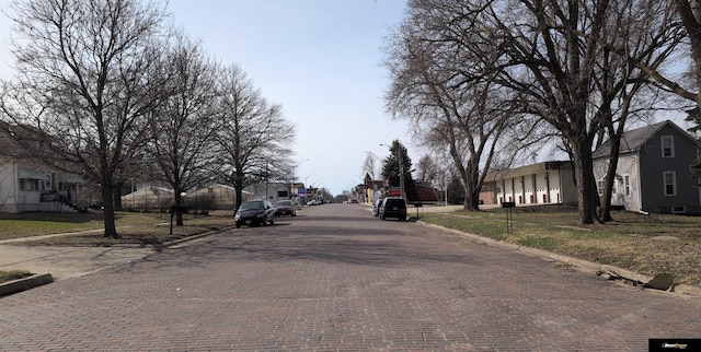 view of street featuring a residential view, curbs, and sidewalks