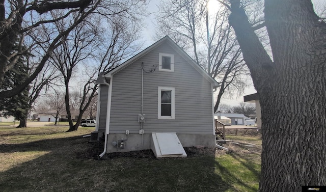 rear view of house with a yard and cooling unit