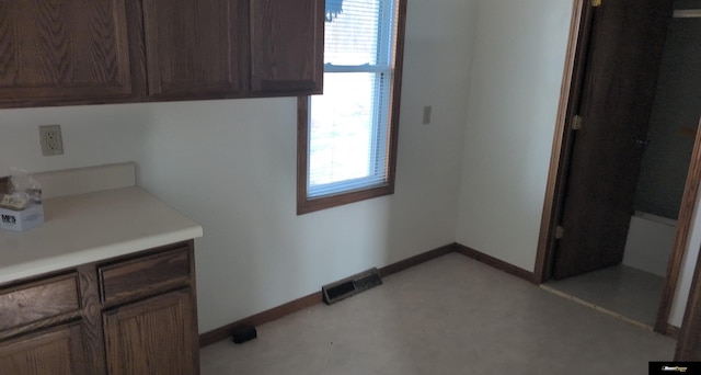 washroom with baseboards, visible vents, and a wealth of natural light