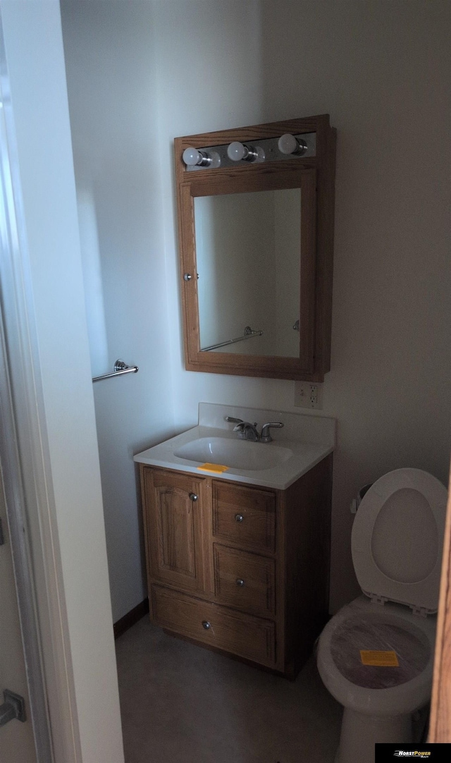 half bathroom featuring toilet and vanity