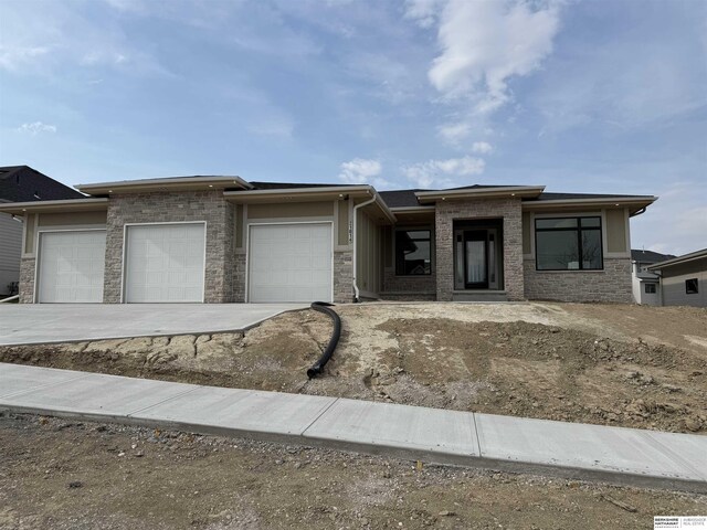 prairie-style house with a garage and driveway