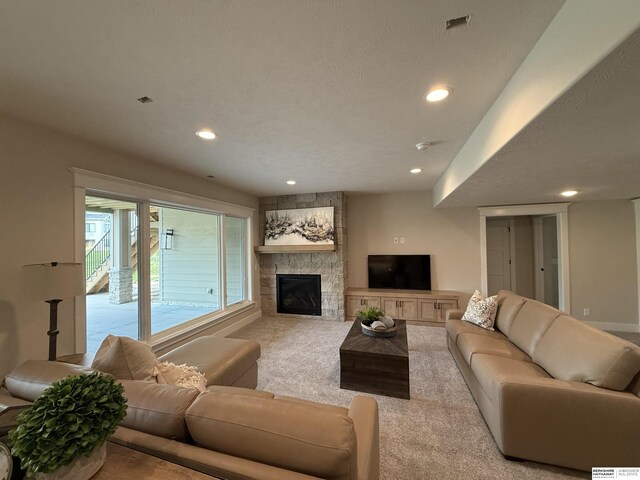 living area featuring recessed lighting, carpet, and a fireplace