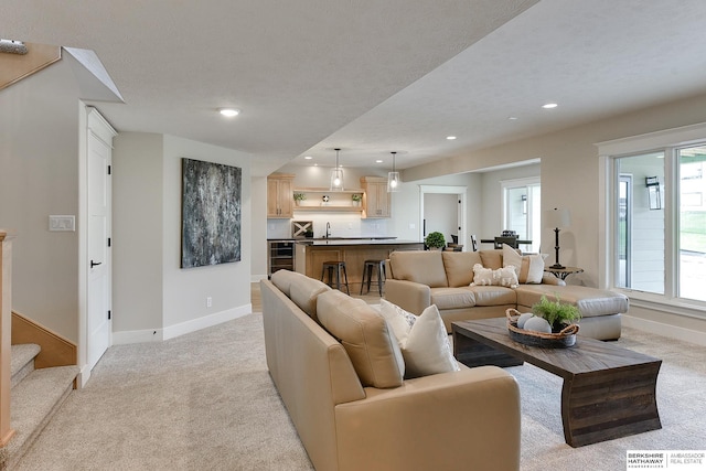 living room featuring light colored carpet, recessed lighting, and baseboards