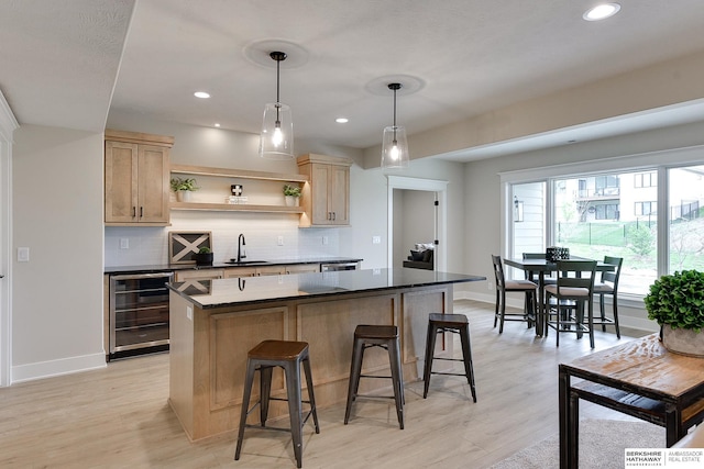 kitchen featuring open shelves, baseboards, a kitchen island, and beverage cooler