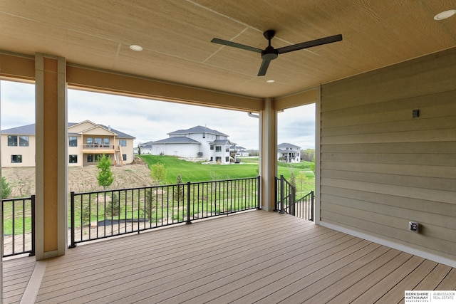 wooden terrace featuring a ceiling fan and a residential view