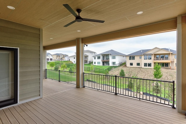 wooden deck featuring a ceiling fan and a residential view