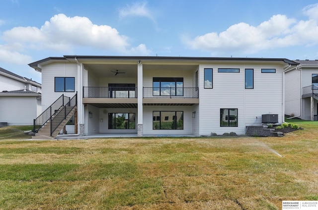 21014 E St, Elkhorn, NE 68022 - rear view of property featuring central AC unit, a balcony, a yard, a patio, and stairway