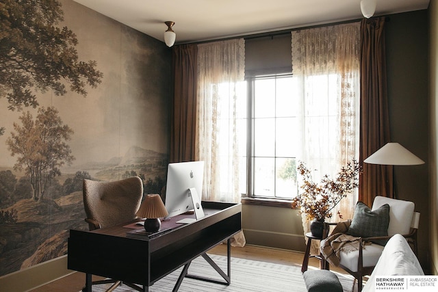 office space with light wood-style flooring and baseboards
