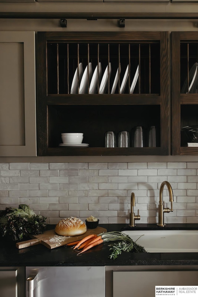details featuring open shelves, dark countertops, a sink, and backsplash