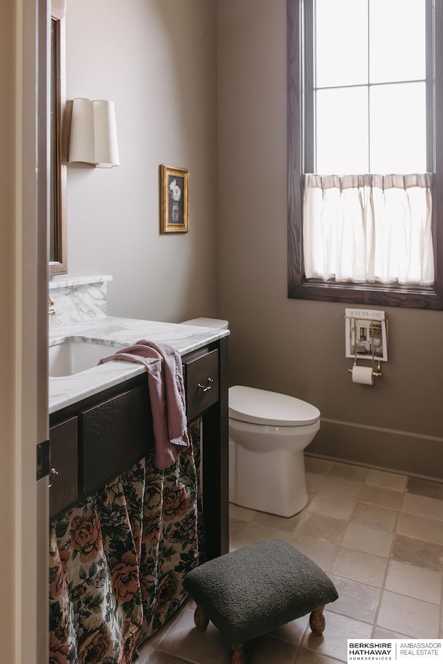 half bathroom featuring toilet and vanity