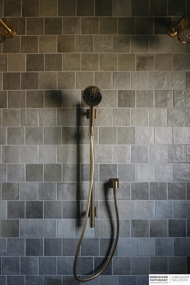 interior details featuring tiled shower