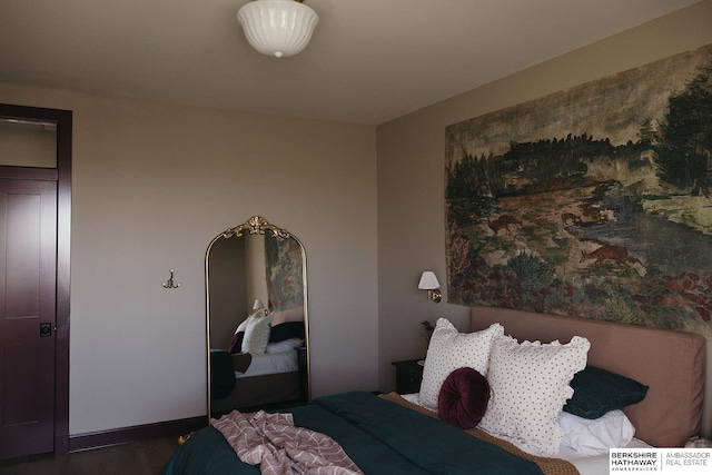 bedroom with baseboards and wood finished floors
