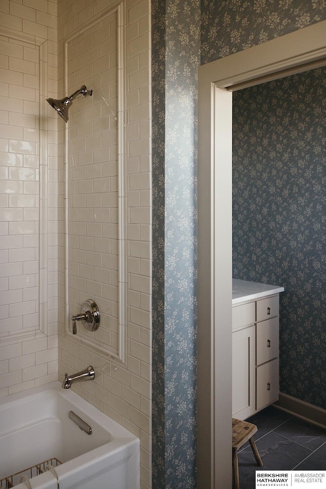 full bath with wallpapered walls, vanity, tile patterned flooring, and  shower combination