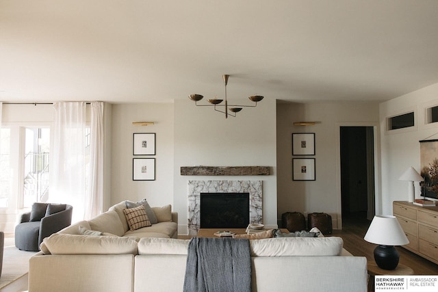 living room with a fireplace and dark wood-style floors