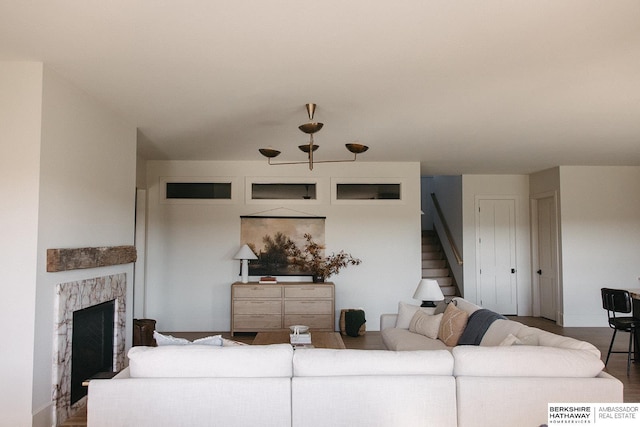 living area featuring a fireplace and stairs