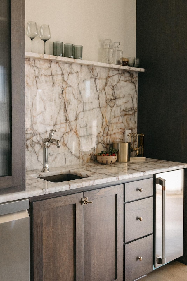 bar featuring backsplash and a sink