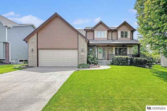 craftsman inspired home featuring brick siding, a porch, concrete driveway, a front lawn, and a garage